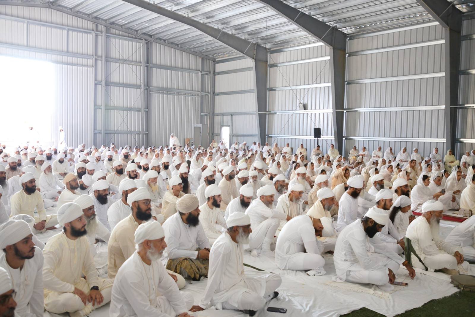 The sangat seated together in white for a diwan